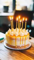 beautiful cake with golden candles celebrates happy anniversary at work, bringing joy to business gathering photo