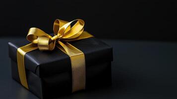 beautiful black gift box with shiny gold ribbon symbolizes happy anniversary and is perfect for any work or business celebration photo