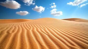 Wind ripples on untouched sand dunes creating patterns under blue sky photo