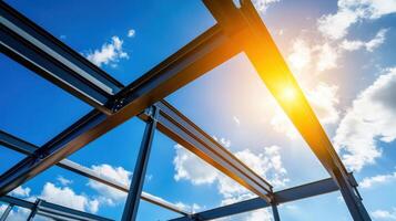 Steel framework under construction against bright blue sky with clouds photo