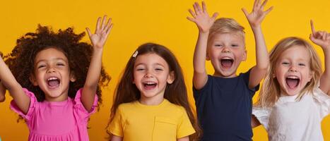 Happy children celebrating with joyful expressions against bright yellow background photo