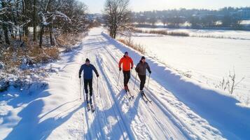 Three people cross country skiing on a snowy trail photo