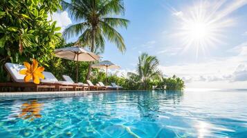 luxurious resort pool overlooking tropical paradise with sun and palm trees photo