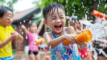 Children playing water games during festival, joyful expressions, summer fun photo