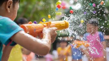 A child is playing with water guns in the park photo