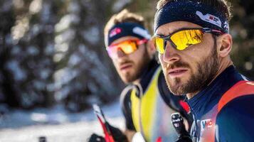 Two men wearing ski goggles and ski gear photo