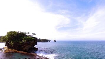 A view of the ocean and a rocky cliff photo