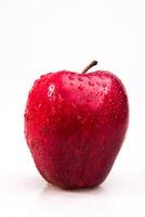 A red apple with water droplets on it photo