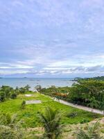 A view of the ocean from a hill overlooking the beach photo