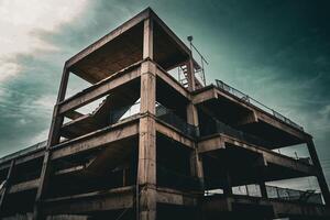 Abandoned concrete structure under a cloudy sky photo