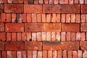 Close-up of a stack of red bricks forming a solid wall photo