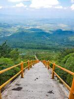 Stairway to a breathtaking view of the green hills and open sky. photo