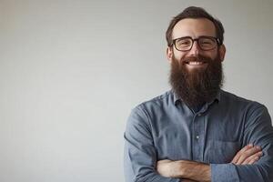 Smiling man with beard and glasses shows confidence in casual setting photo