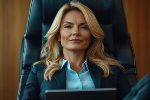 Professional woman sitting confidently in an office setting during a business meeting photo