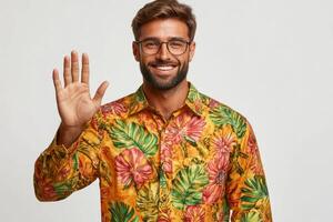 Smiling man in colorful shirt waves with enthusiasm in a cheerful studio setting photo