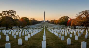 Rows of headstones in a cemetery facing a monument at sunset photo