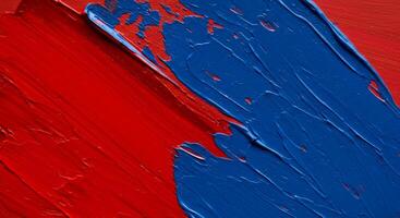 Diagonal strokes of red and blue oil paint on a surface photo