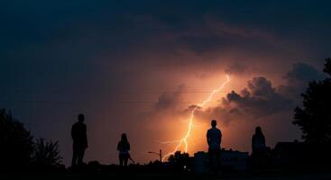 People watching spectacular lightning illuminate the dark sky outside photo