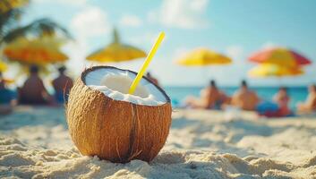 Coconut drink resting on sandy beach, sunbathing tourists enjoying tropical paradise in soft-focus background photo