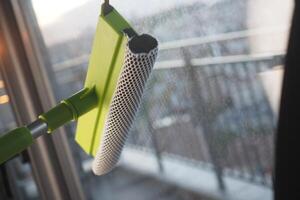 Window cleaning tool in action on a modern balcony photo