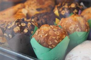 Freshly baked muffins displayed in a pastry shop window photo