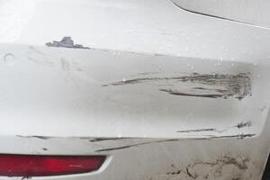 Car bumper with scratches and scuff marks after minor collision photo