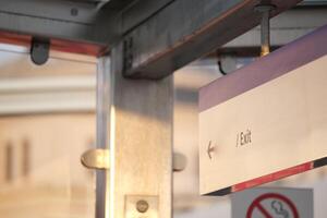 Exit sign in urban transit station during late afternoon light photo