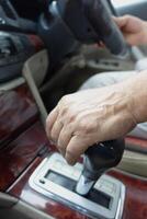 Hand gripping gear shift while driving in a modern vehicle photo