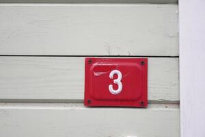 Number three displayed on a rustic wooden wall panel photo