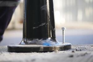 Fixing a pole base on a city street during daylight hours photo