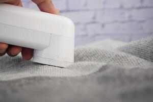 How to effectively remove lint from clothing using a lint remover photo