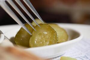 Sliced pickles arranged on a small dish ready for tasting photo
