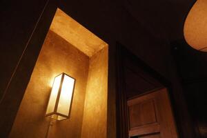 Soft lighting in a cozy corner of a dimly lit room photo