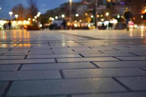 Evening walk on the illuminated city pavement at dusk photo