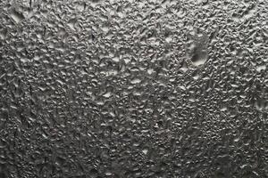 Close-up view of raindrops on a window during a rainstorm photo