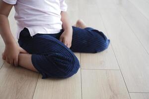 Cerebral palsy child sitting with w shape photo