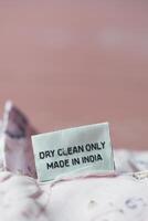 Label showing dry clean instructions on fabric made in India photo