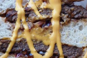 Delicious grilled burger with melted cheese on soft bread photo