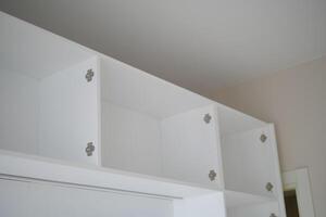 Modern white shelving units in a minimalistic interior design photo