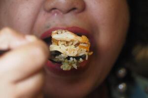 Enjoying a delicious bite of fried rice with chicken at dinner photo