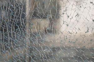 Shattered glass displaying intricate patterns in bright light photo