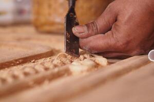 Crafting intricate woodwork in a workshop during daylight hours photo