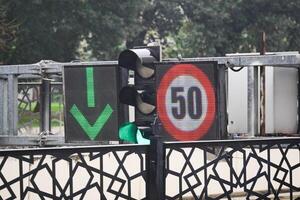Green arrow signal with speed limit display at a busy intersection photo