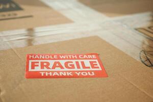 Box labeled fragile handled with care at a shipping facility photo