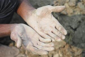 Hands covered in mud after working in the field photo