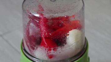 A blender with red peppers and other ingredients in it video