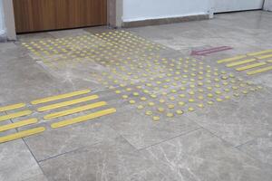 Textured surface markings guide safe movement in public space photo