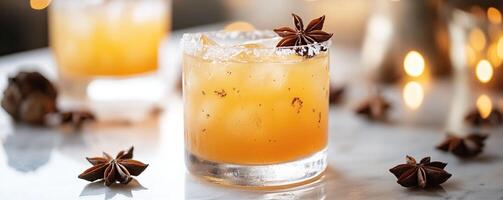 A refreshing cocktail with ice and star anise garnishing, set against a blurred background with warm lighting. photo