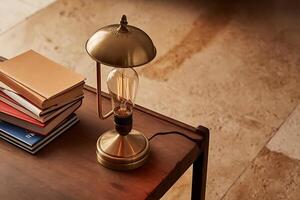A table with a lamp and books on it photo