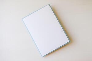 A blank white notebook on a white surface photo